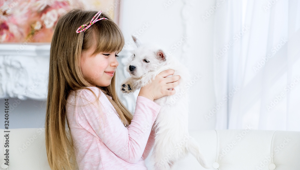 child hugs a white terrier puppy child hugs a white terrier puppy