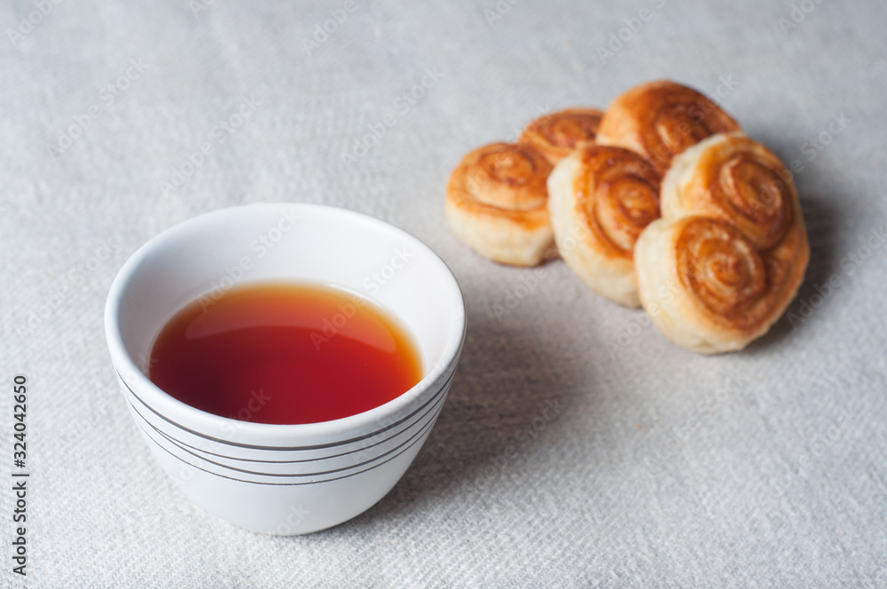 Tea mug and fresh pastries. Light morning breakfast. Fresh homemade cakes Tea mug and fresh pastries. Light morning breakfast. Fresh homemade cakes