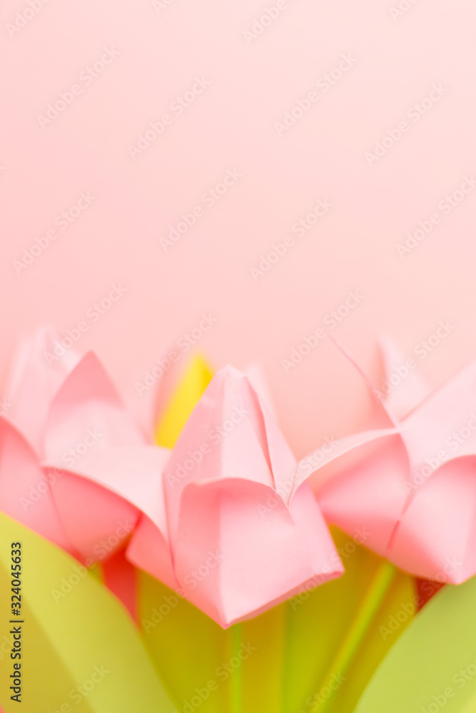 Close up pink paper tulips on pink background. Copy space. Happy International Women's Day, March 8, Mother's Day, Mom's day. Place for text and design. Greeting card. Selective focus