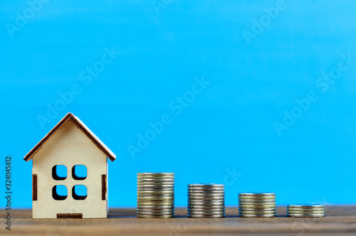 wooden house and coins, housing sale concept