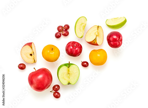 Fruits healthy food summer color layout. Apple, plum, grape isolated on white. Detox fruity health diet creative concept. Colorful fresh raw fruit, green apple vitamin background, top view.
