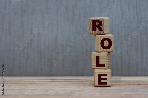 concept word role on wooden cubes on a gray background photo