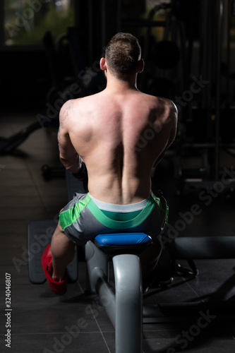 Muscular Man Doing Heavy Weight Exercise For Back © Jale Ibrak