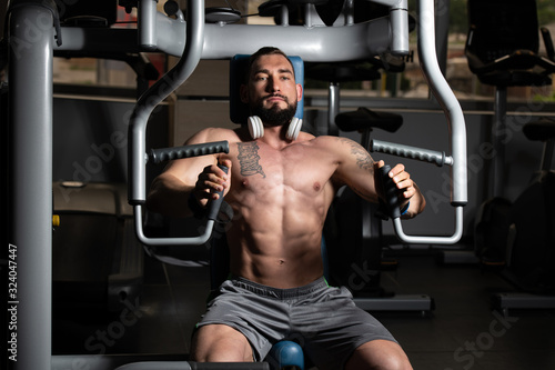Bodybuilder Exercising Chest On Machine