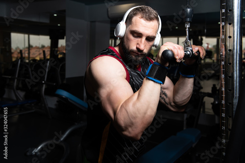 Bodybuilder Doing Heavy Exercise For Triceps With Cable