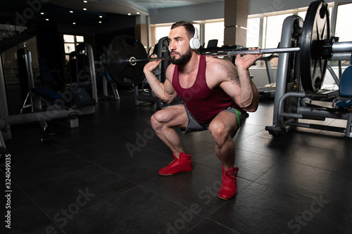 Man Doing Heavy Weight Exercise With Barbell