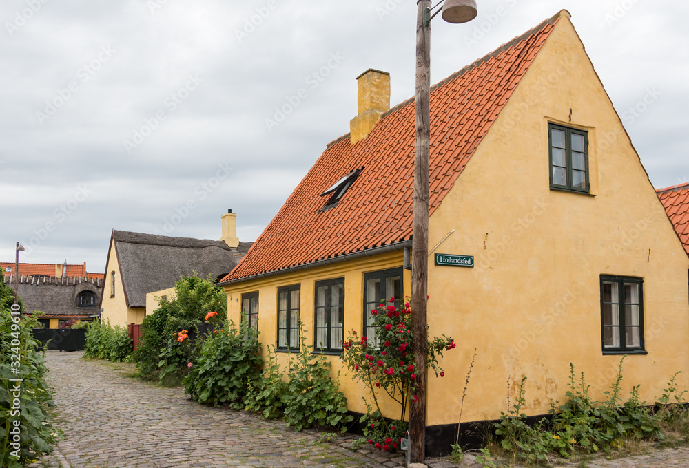 Old, traditional Danish houses in narrow, cobbled stone street in the fishermen's village Dragør, Denmark.