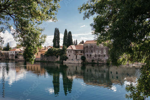 Picturesque landscape view of beautiful old city of Trebinje and Trebisnjica river  Bosnia and Herzegovina. Reflections of city on river. September  2018.