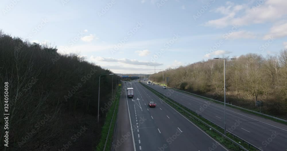 Denham, UK - January 10 2020: Wide shot looking west of cars driving towards and away from London on the busy M40 at the M25 junction Denham, UK - January 10 2020: Wide shot looking west of cars driving towards and away from London on the busy M40 at the M25 junction