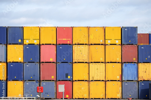 Obraz na plátne Colorful freight containers stacked up on the quay for shipping in the cargo por