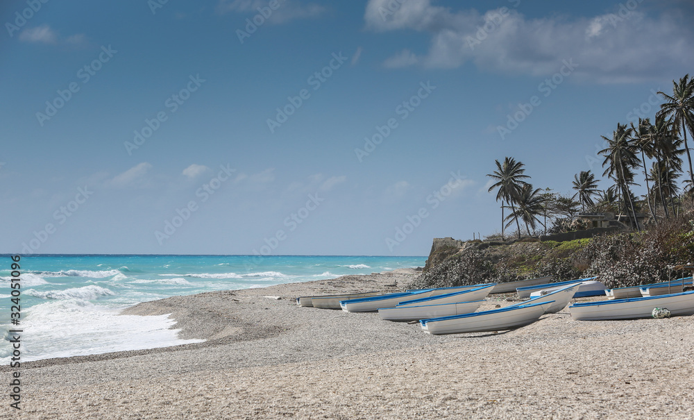 dramatic image of fishing boats on the caribbean coast in Los Patos, dominican republic. dramatic image of fishing boats on the caribbean coast in Los Patos, dominican republic.