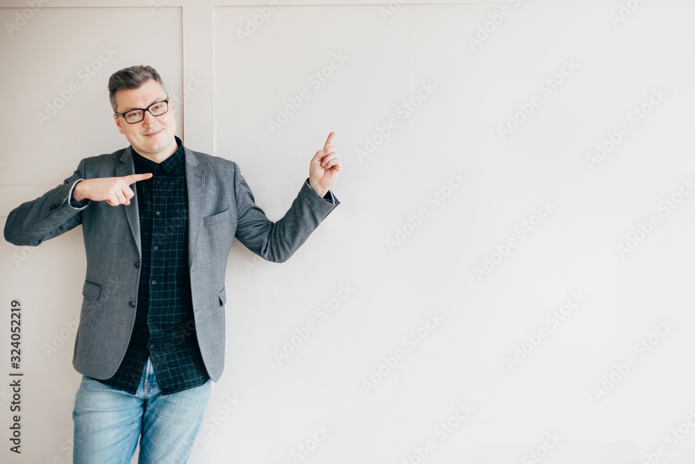 Successful businessman in modern office, pointing on copy space. Business, professional occupation and career Successful businessman in modern office, pointing on copy space. Business, professional occupation and career