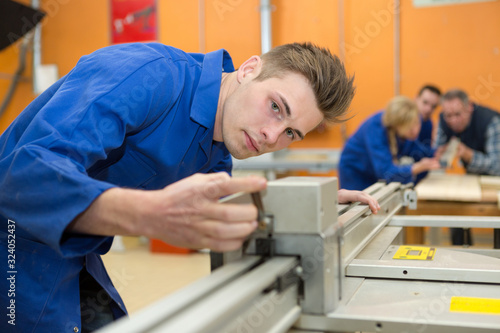 young man cutting in a factory