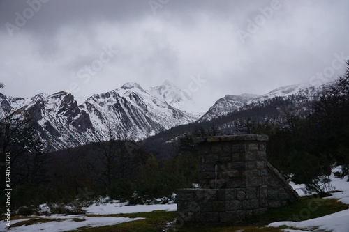 spring with snowy mountains in the north of spain, picos de europa