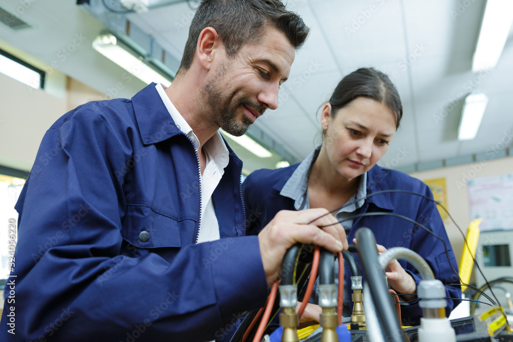 painter and electrician standing side by side painter and electrician standing side by side