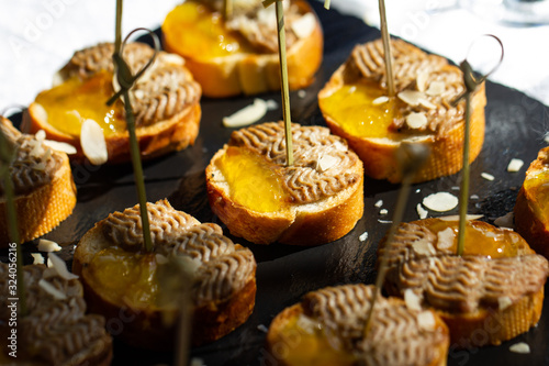 Canapes with white bread, pate and honey. Selective focus.