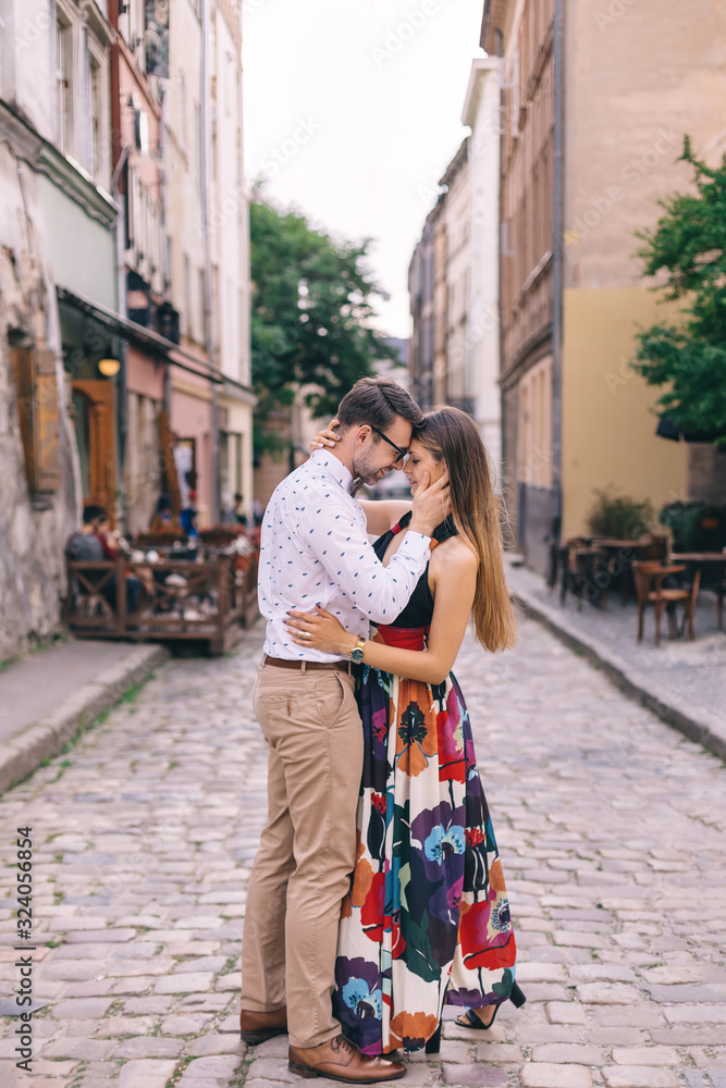 couple in love leaned their heads and hugging on the city street couple in love leaned their heads and hugging on the city street