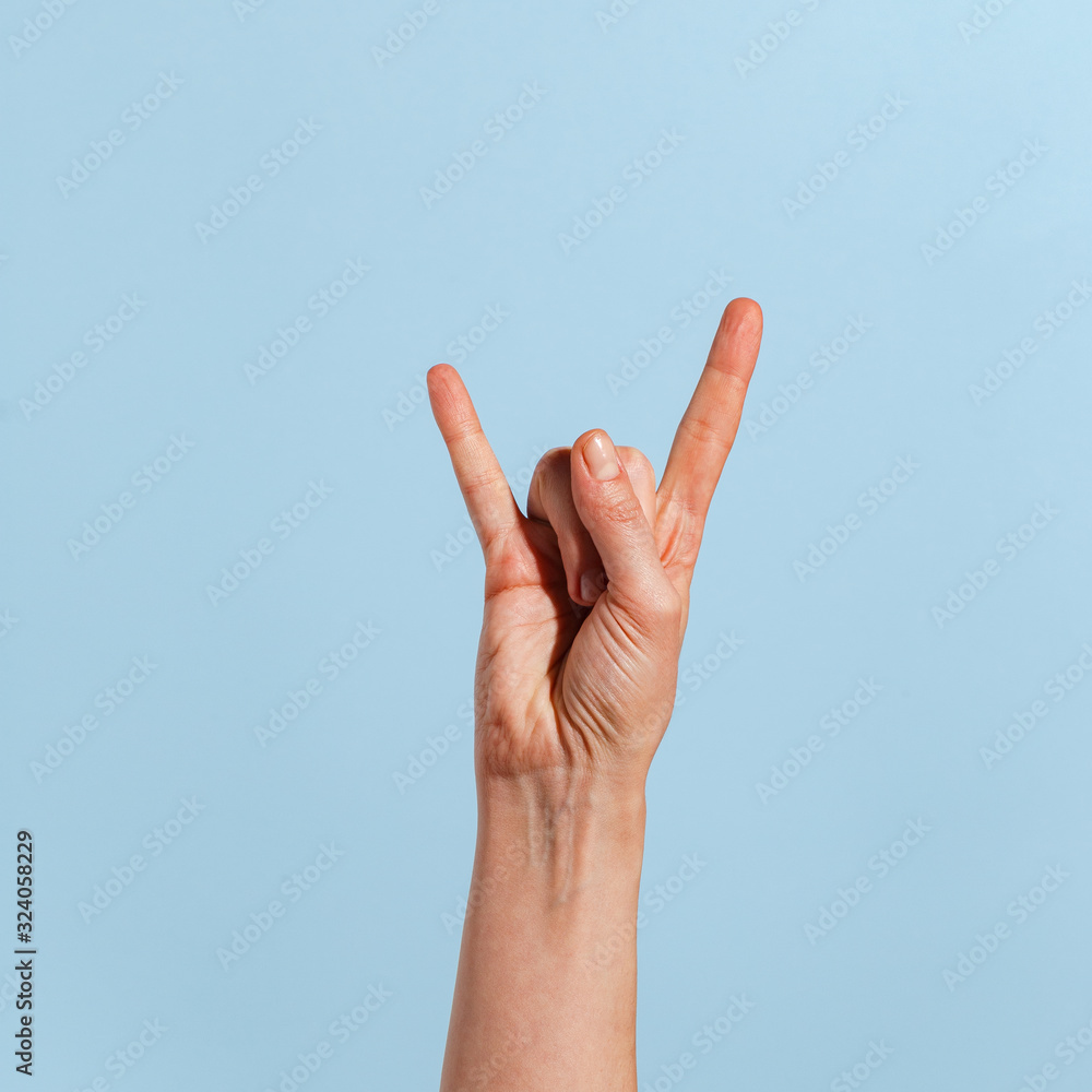 Female hand on a blue background in various positions. Female hand on a blue background in various positions.