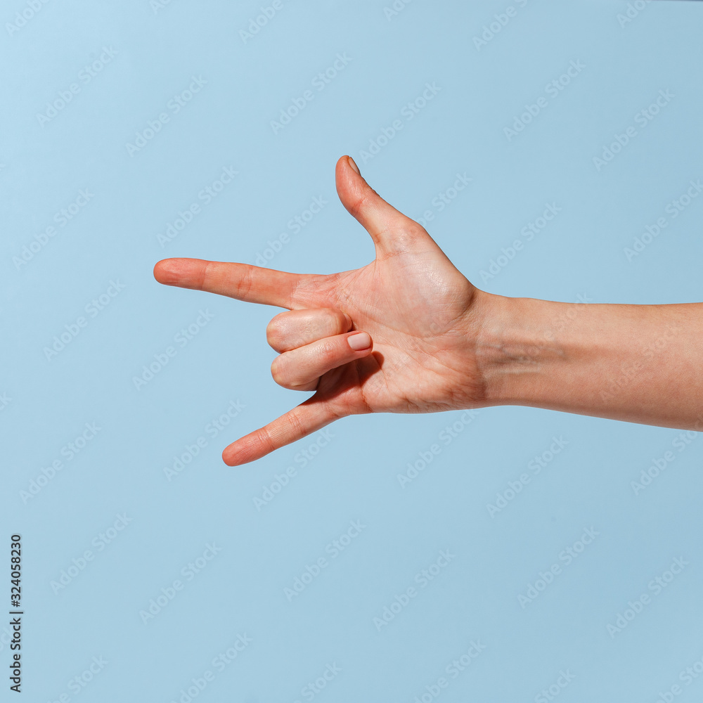 Female hand on a blue background in various positions. Female hand on a blue background in various positions.