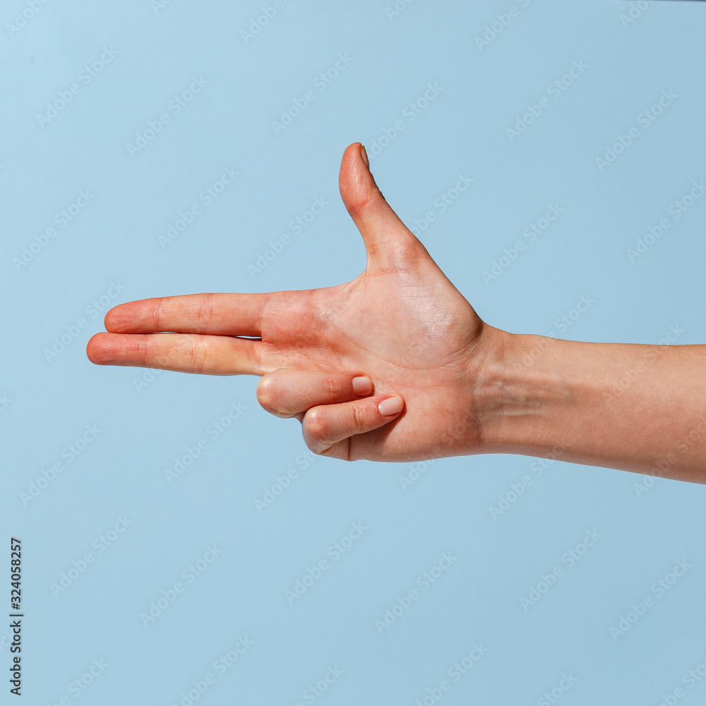 Female hand on a blue background in various positions. Female hand on a blue background in various positions.