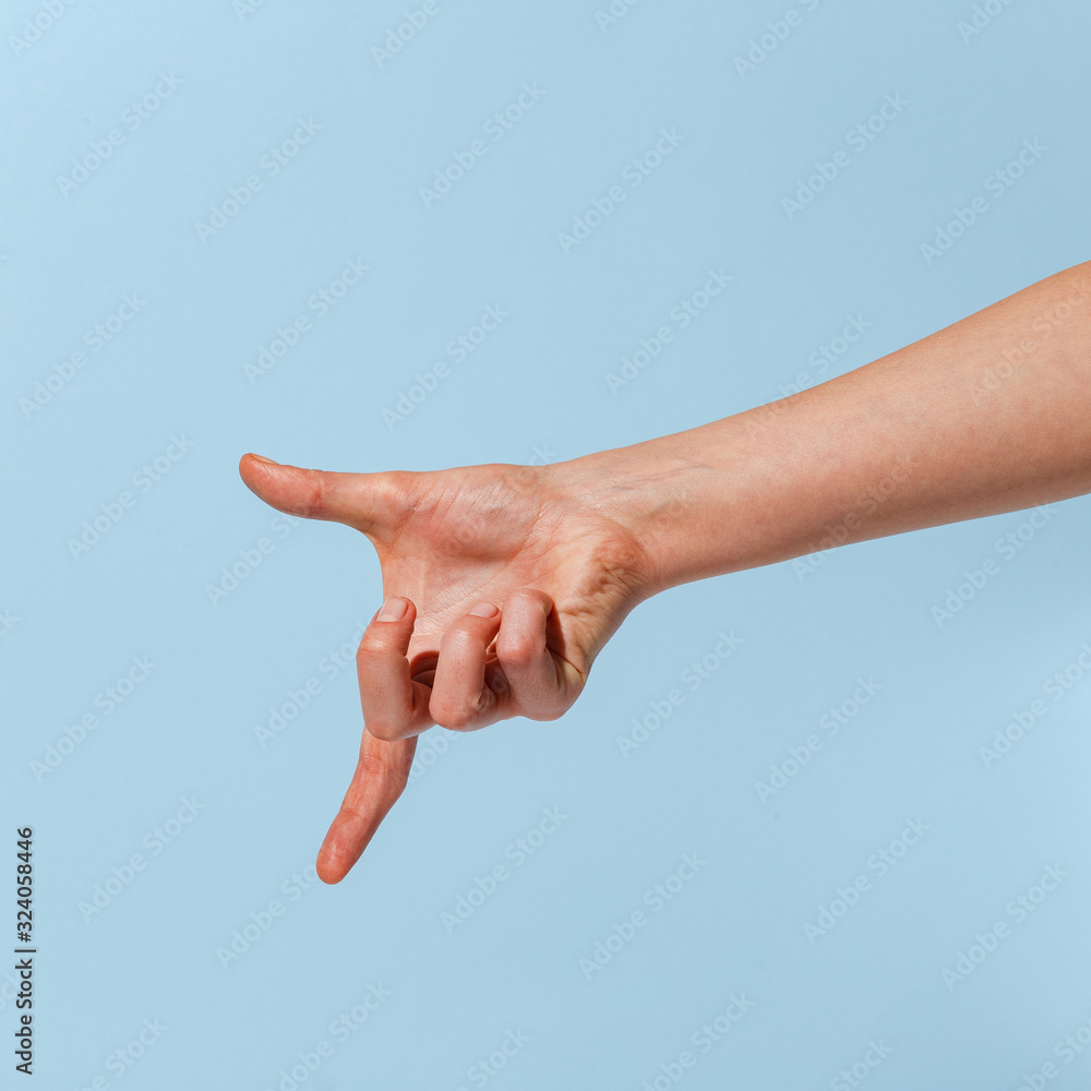 Female hand on a blue background in various positions.