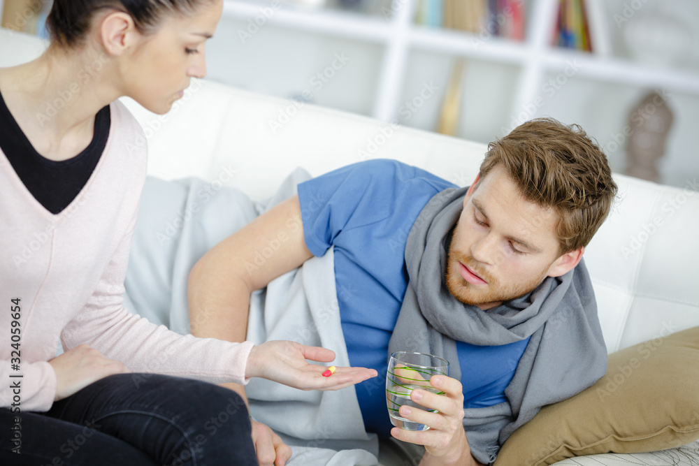 beautiful ill woman giving her boyfriend a pill beautiful ill woman giving her boyfriend a pill