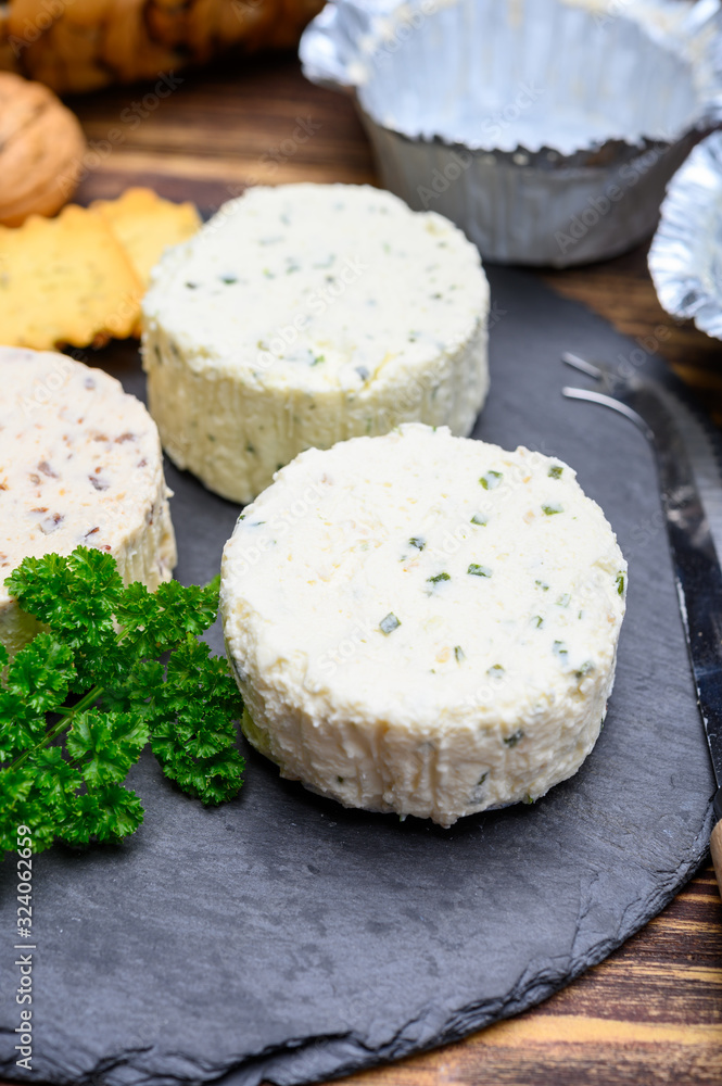 Spread cream cheese with herbs, garlic, chives and spices close up Spread cream cheese with herbs, garlic, chives and spices close up