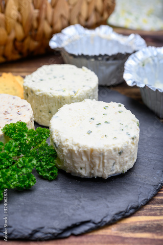 Spread cream cheese with herbs, garlic, chives and spices close up
