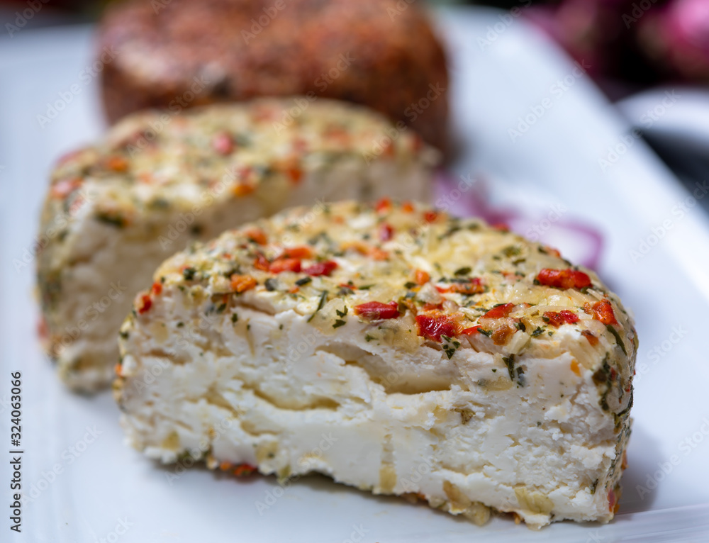Different french soft goat cheeses made with spices and herbs
