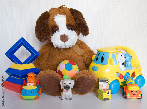 Plush dog with different plastic toys