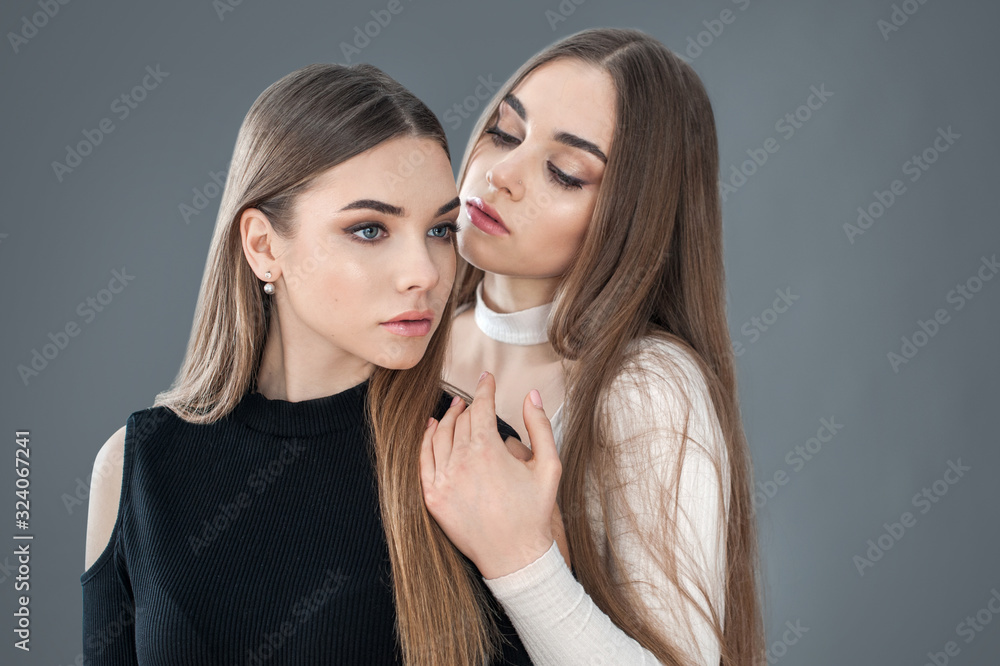 two beautiful sisters dressed in white and black, concept of lifestyle of people, girlfriends two beautiful sisters dressed in white and black, concept of lifestyle of people, girlfriends