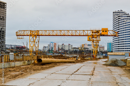 A construction site with specialized professional equipment and cranes during the construction of a modern line of the underground metro station in the big city of the metropolis