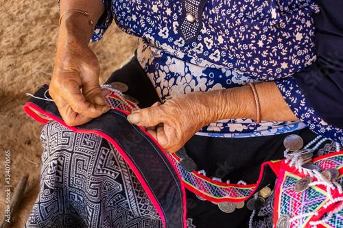 Woman seated stitching, making tradtional garments, Vang Vieng, Laos,Vang Vieng photo