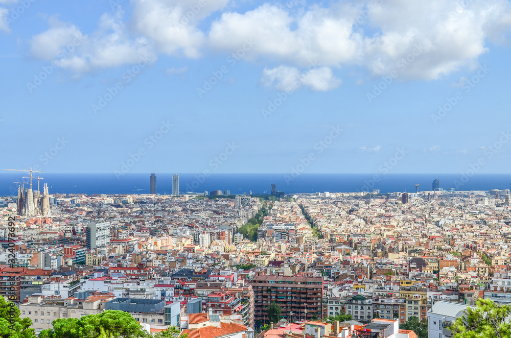 The view from the Hill of Three Crosses in the Güell Park to the Mediterranean Sea and the Eixample or New Town is the most populated area of ​​Spanish Barcelona. Passeig de Sant Joan in the center