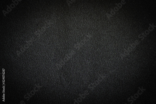 Black fabric, luxury dark gray background abstract. Material are used in textile assembly. Detail cloth texture of pattern. Design, elegance with vignette effect, free copy space for text placement.