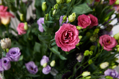 Beautiful multicolored flowers bouquet. Different color roses in the floral shop. Lush bouquet for the special moment. Wedding day.