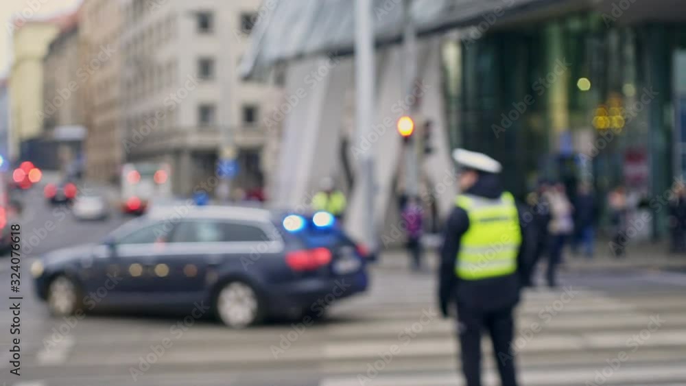 Blurred policemen controlling traffic on road Blurred policemen controlling traffic on road