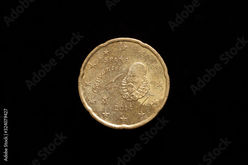 Spanish 20 Euro Cent coin from 2014, obverse showing portrait of Miguel de Cervantes. Isolated on black background