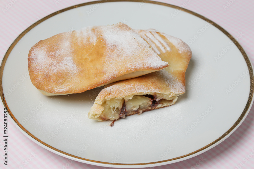 Sweet pineapple chocolate pastry roll with sugar icing Sweet pineapple chocolate pastry roll with sugar icing