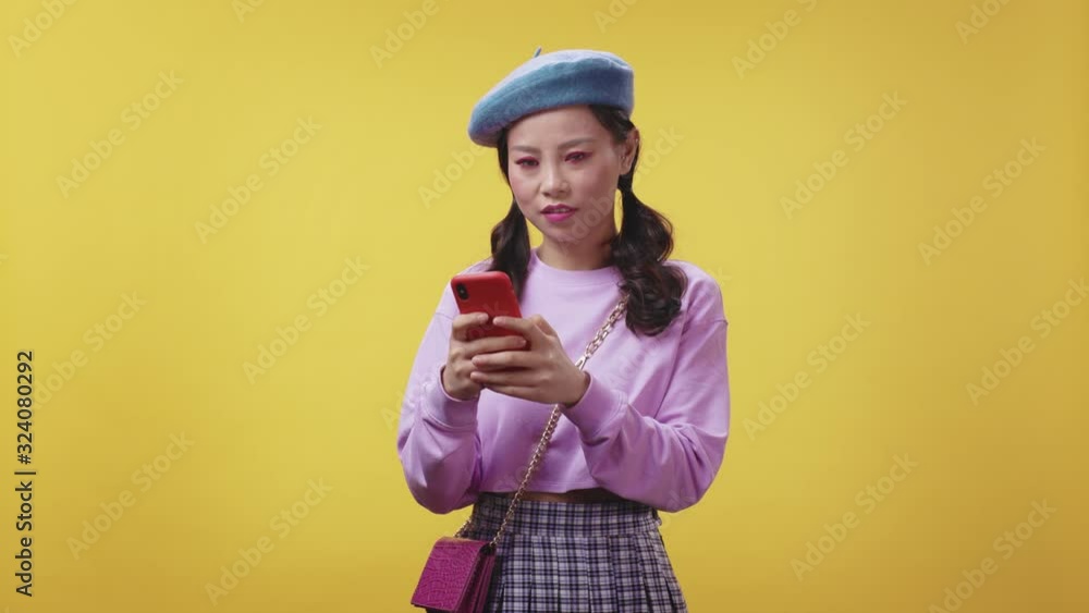 Unhappy asian girl receiving bad message news on smartphone shaking head in refusal. Negative expressions. Bad mood concept. Unhappy asian girl receiving bad message news on smartphone shaking head in refusal. Negative expressions. Bad mood concept.