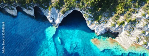 Panel kuchenny z motywem Aerial drone ultra wide photo of tropical white rocky bay of blue lagoon with turquoise clear waters, white volcanic caves and sail boats docked, island of Paxos, Ionian, Greece