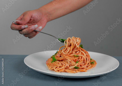 Spaghetti in red sauce with pork ham