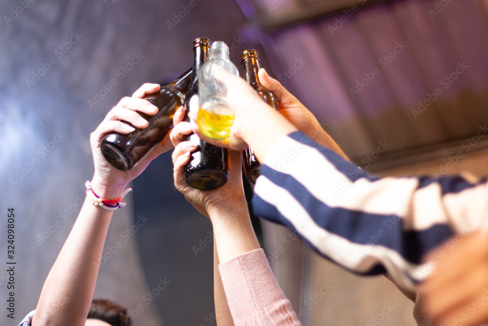 group of people clinking glass bottles of beer party after work group of people clinking glass bottles of beer party after work