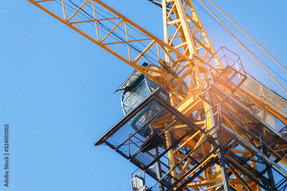 Building crane under construction against blue sky Building crane under construction against blue sky