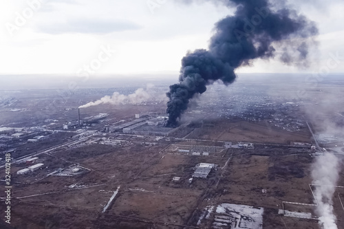 major fire at the factory. dark puffs of smoke from buildings.