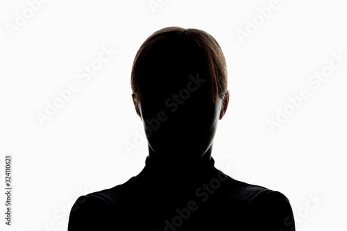 Dark silhouette of girl isolated on white background, the concept of anonymity photo