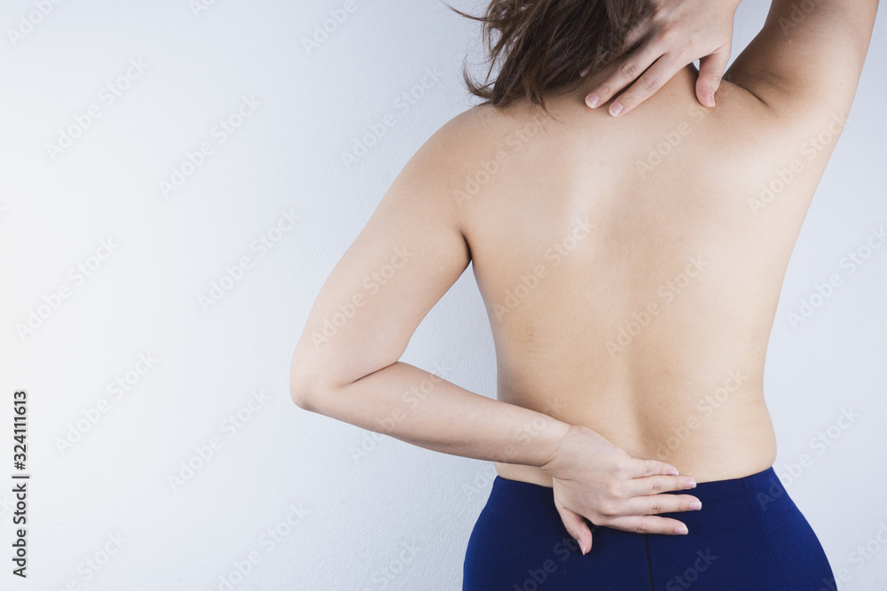 Closeup woman suffering from lower back and neck pain. Health care and medical concept. Closeup woman suffering from lower back and neck pain. Health care and medical concept.