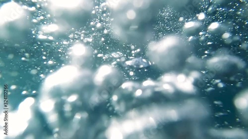 POV slow motion video of diver diving in ocean clear water and releasing air bubbles