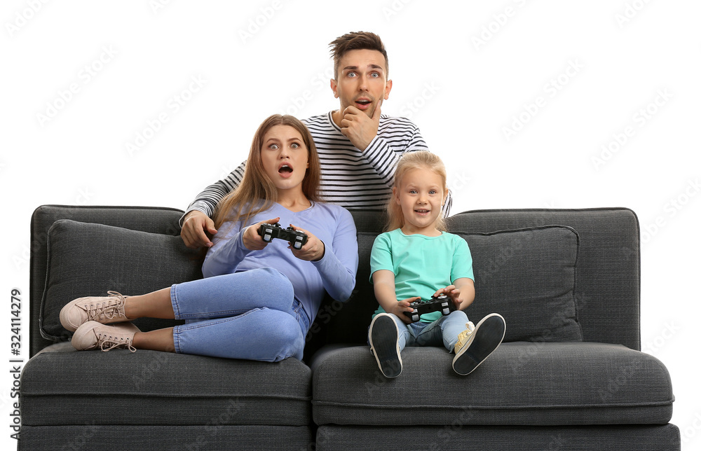 Young family playing video games while sitting on sofa against white background Young family playing video games while sitting on sofa against white background