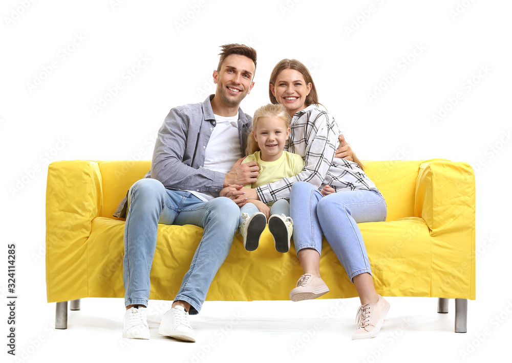 Happy young family sitting on sofa against white background Happy young family sitting on sofa against white background